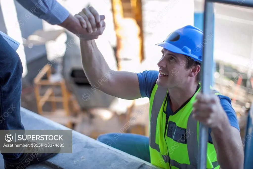 Construction worker shaking hands on construction site