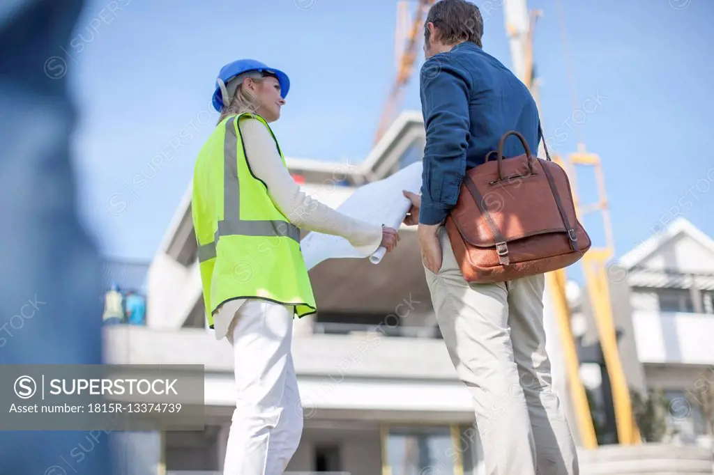 Man and woman looking on construction plan