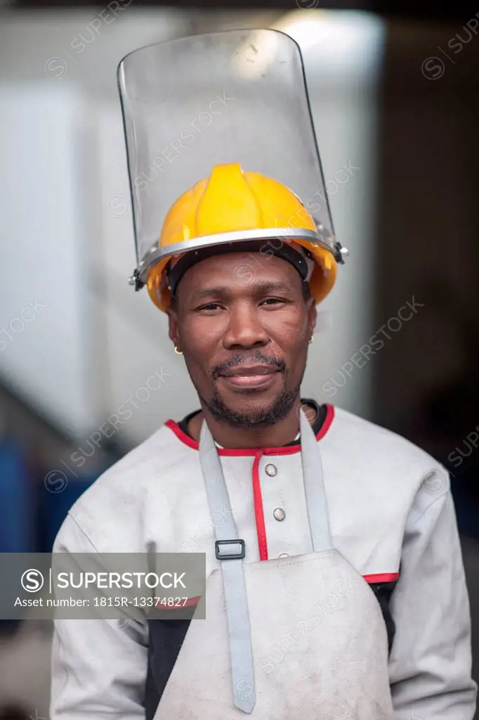 Portrait of confident worker wearing safety helmet