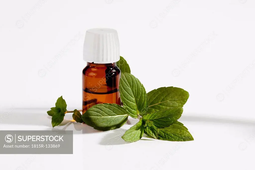 Japanese Mint with on bottle of medicine on white background, close up