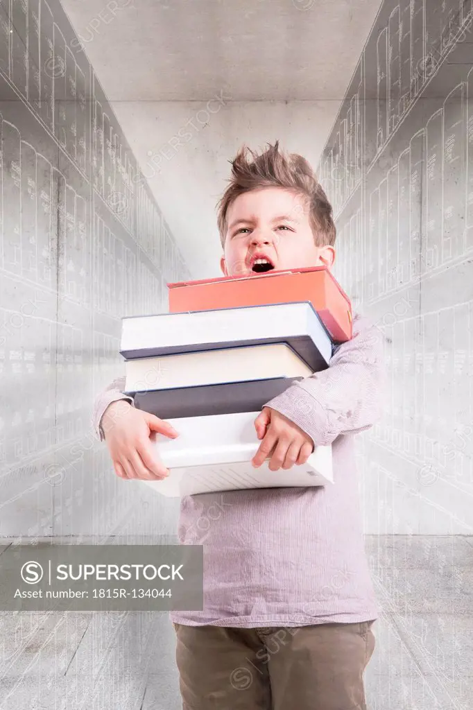Germany, Brandenburg, Boy holding stack of books