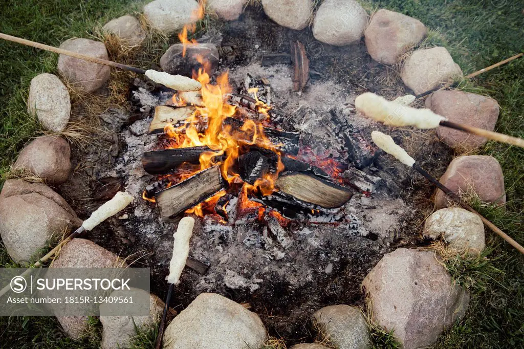 Campfire with twist bread on sticks