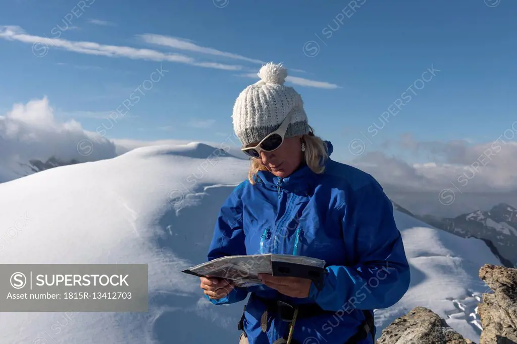 Switzerland, Woman looking at map at Bertol Hut