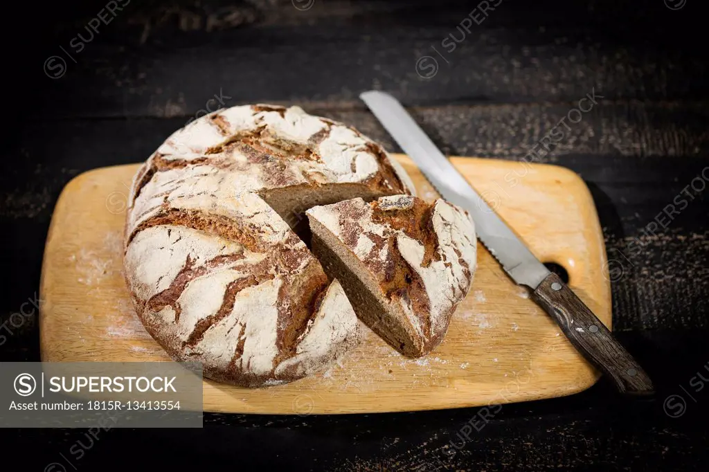 Rustic rye bread on chopping board