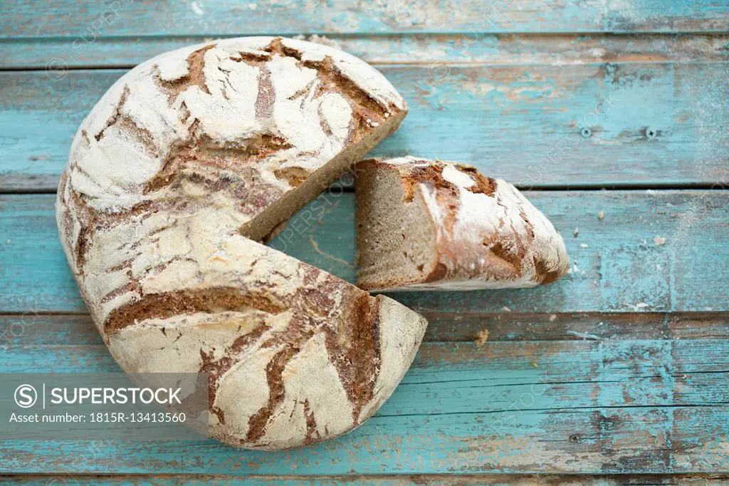 Rustic rye bread on blue wood