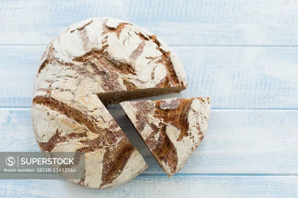 Rustic rye bread on blue wood