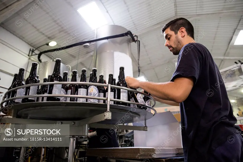 Man working in beer bottling plant