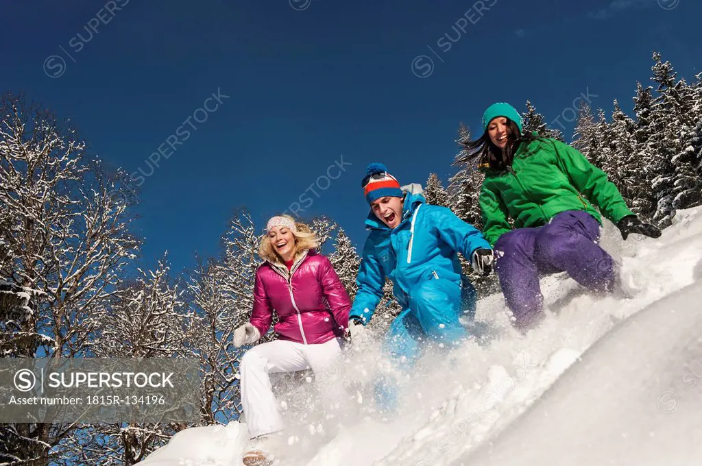 Austria, Salzburg, Young women and man having fun in snow at Altenmarkt Zauchensee