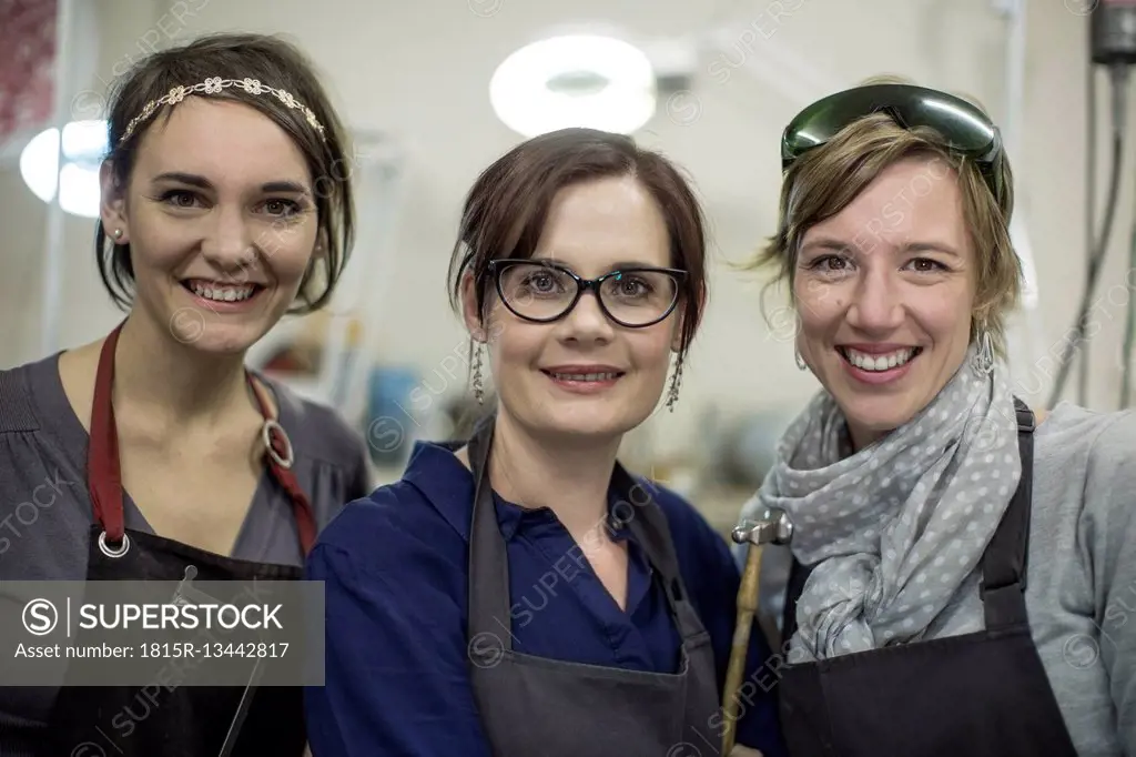 Portrait of three smiling female goldsmiths