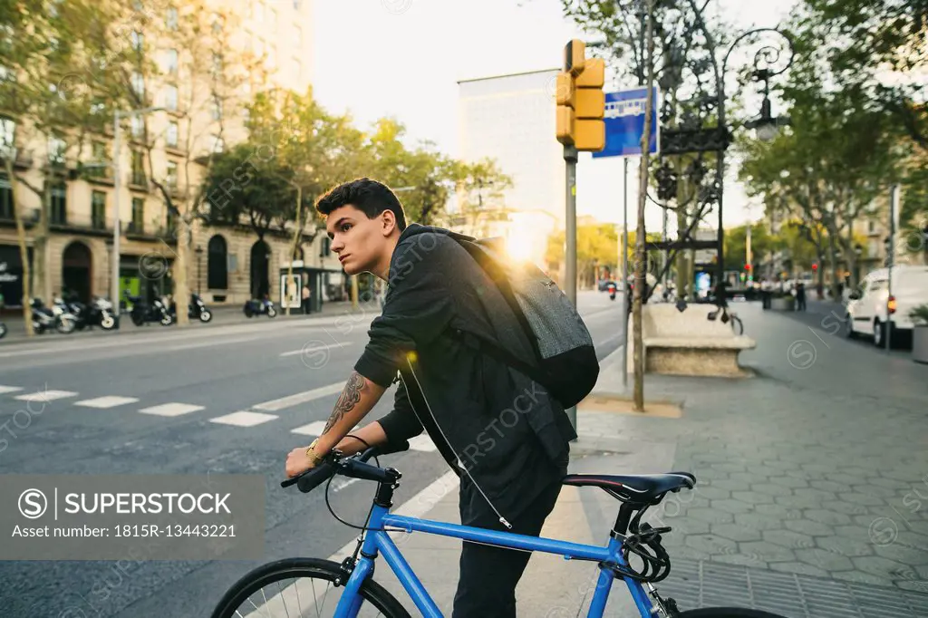 Teenager with a bike in the city