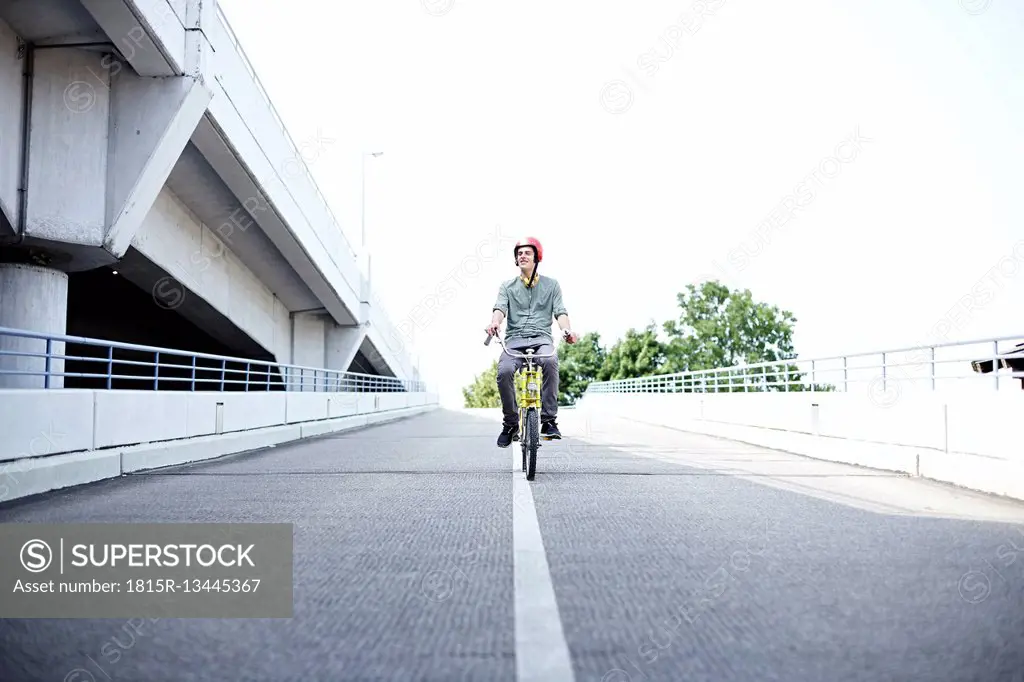 Teenage boy riding bicycle
