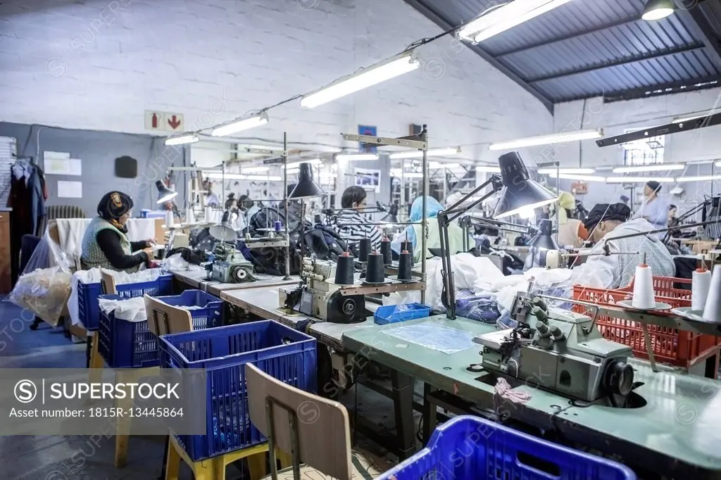 Seamstresses in factory sewing clothes