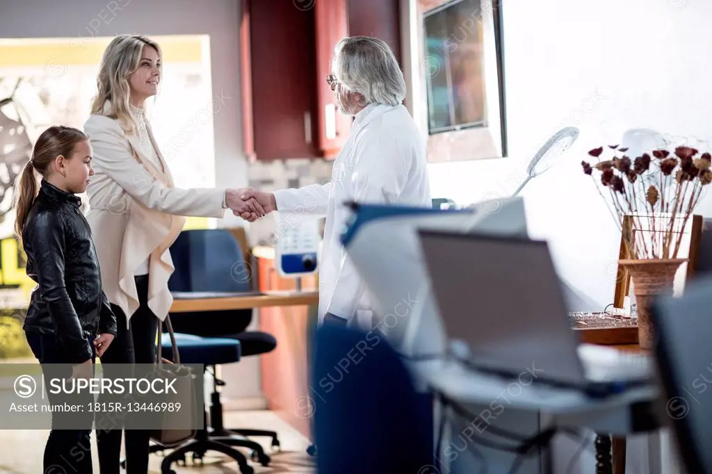 Doctor greeting patients in medical practice