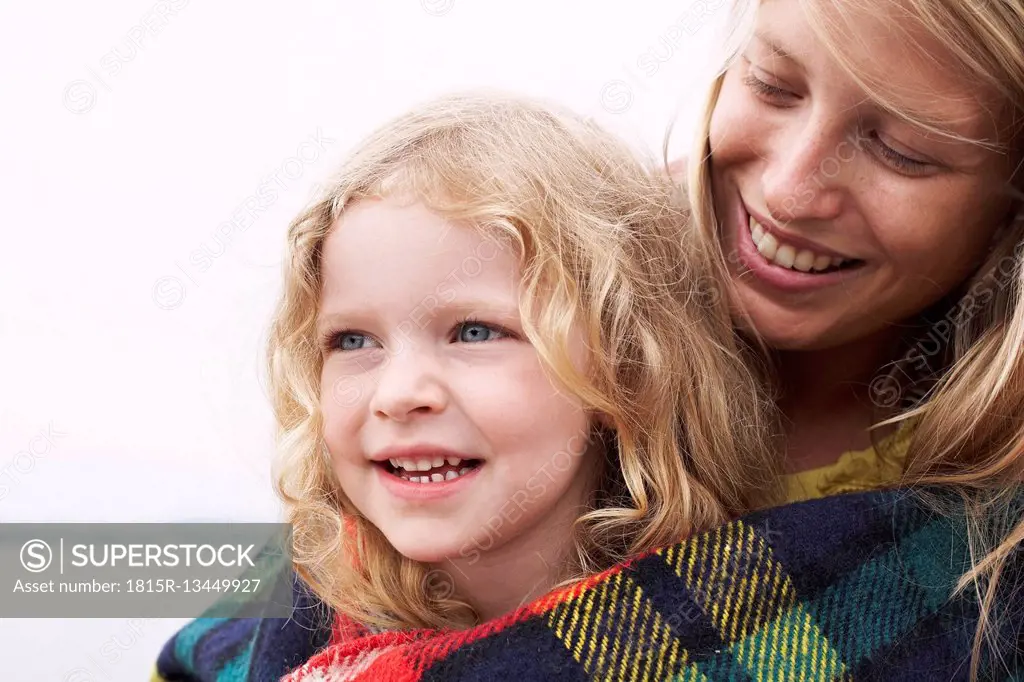 Mother with daughter wrapped in a blanket