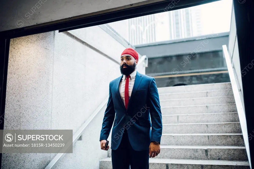 Indian businessman walking down stairs