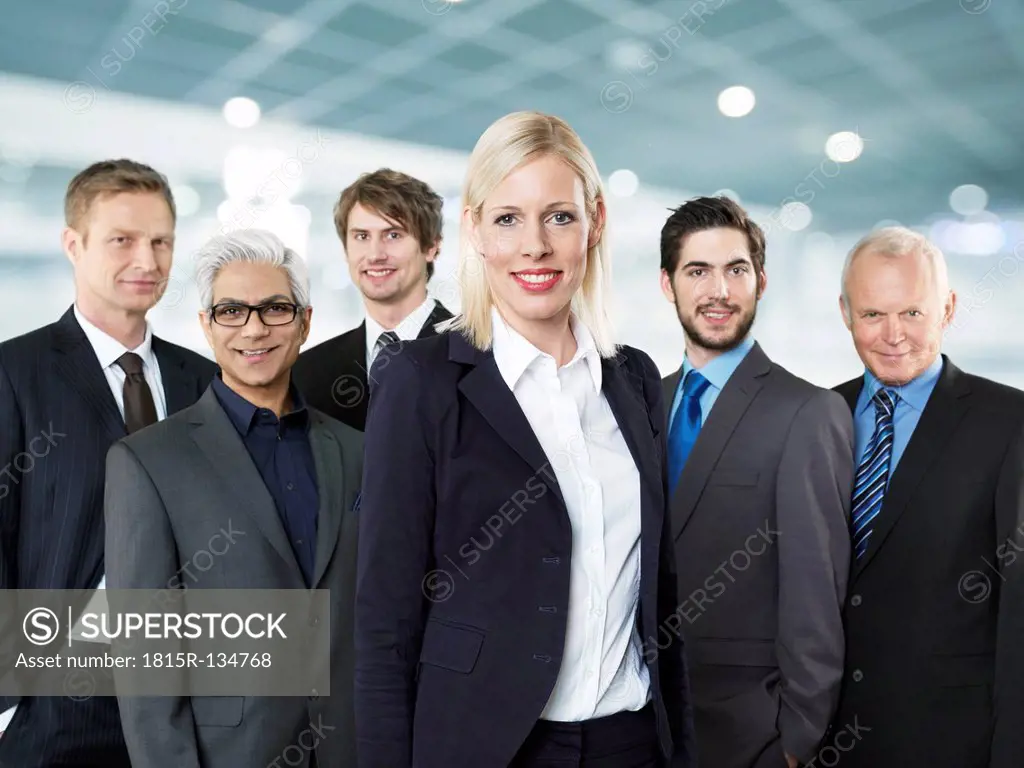 Portrait of businessmen and woman, smiling
