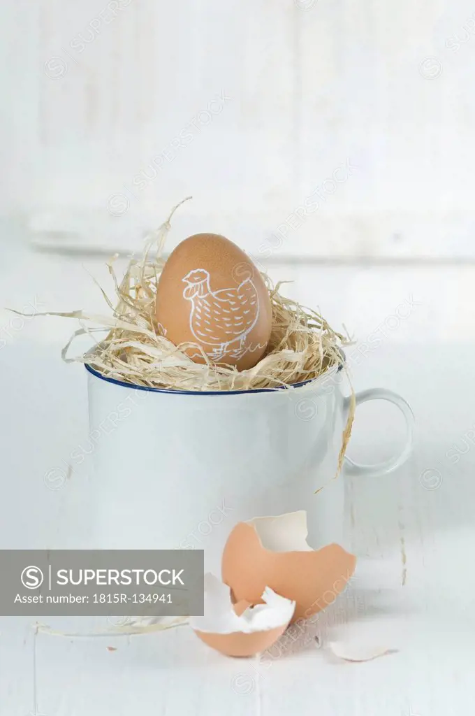 Painted easter egg in straw nest, close up