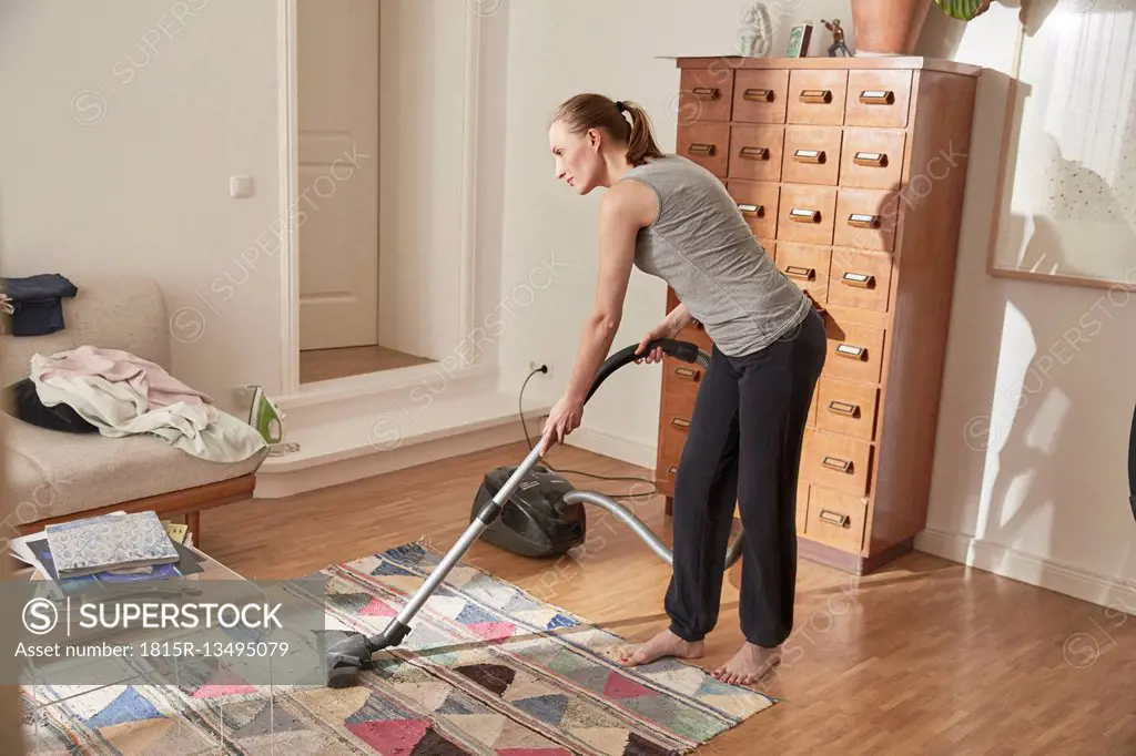 Woman vacuum cleaning at home