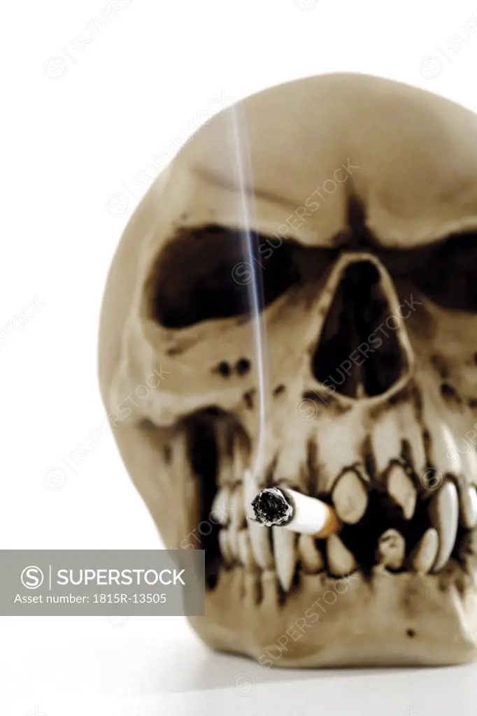 Skull with burning cigarette, close-up