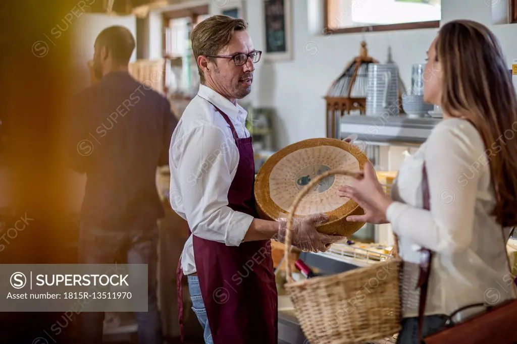Grocer talking to customer in a farm shop