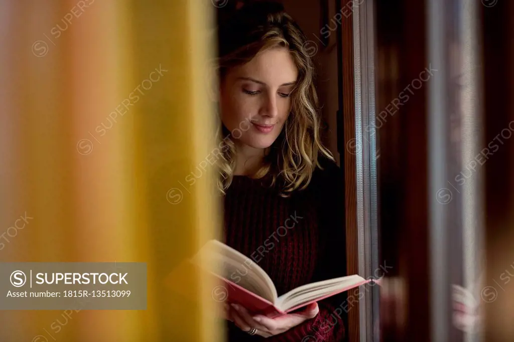 Woman reading a book at home
