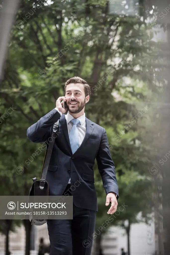 Smiling businessman on cell phone