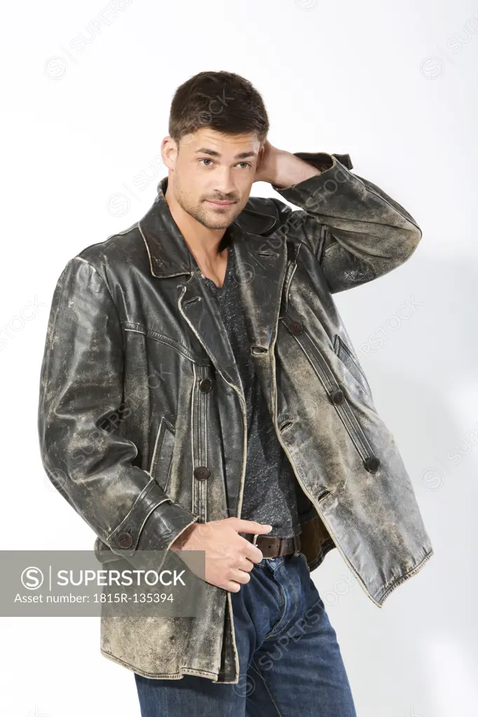 Young man wearing leather jacket, looking away