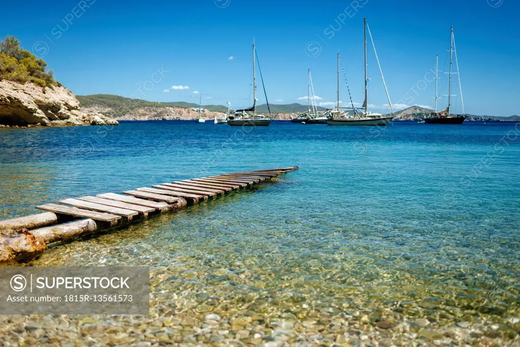 Spain, Ibiza, Jetty in bay with sailing boats