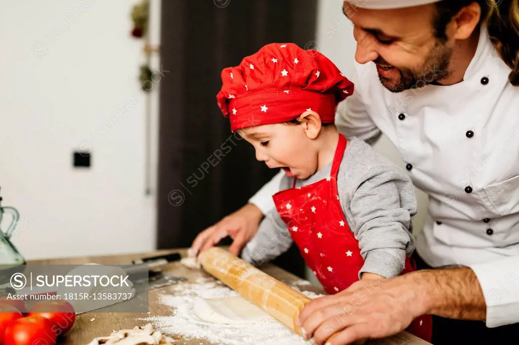 Father and son preparing pizza together