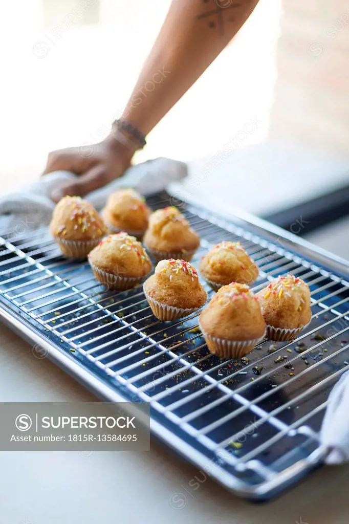 Man holding tray with muffins