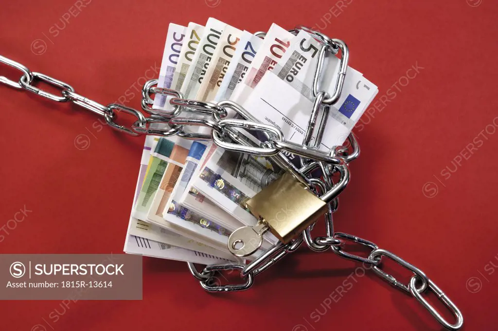 Bunches of Euro banknotes in chains