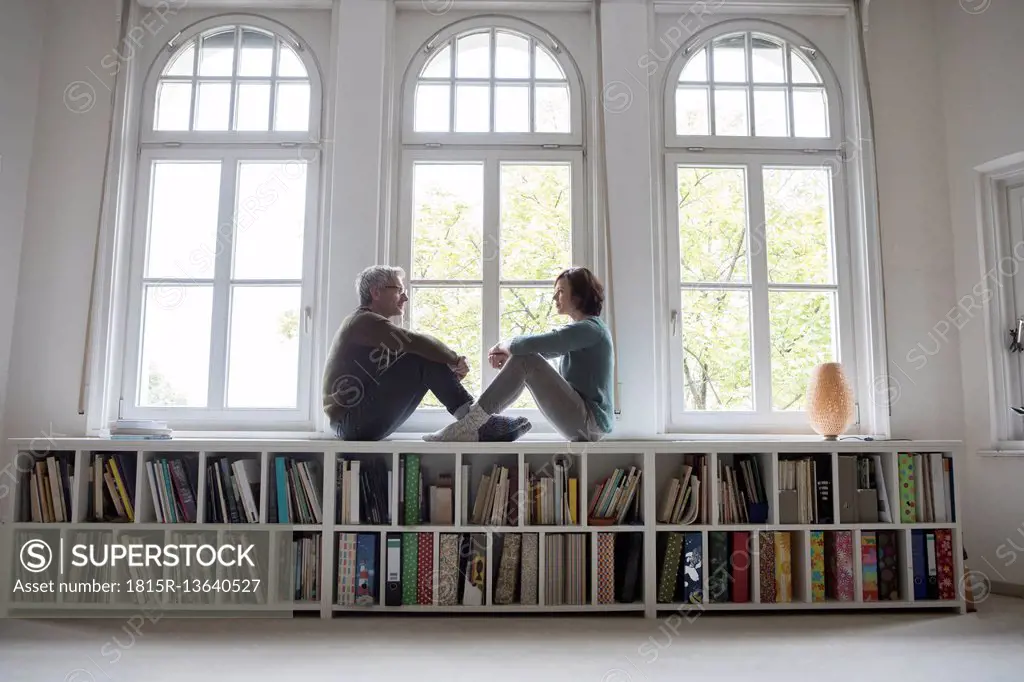 Mature couple sitting at the window