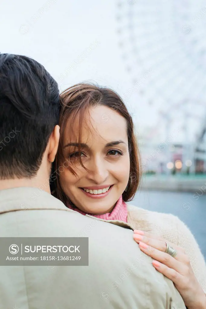 Portrait of smiling woman hugging boyfriend