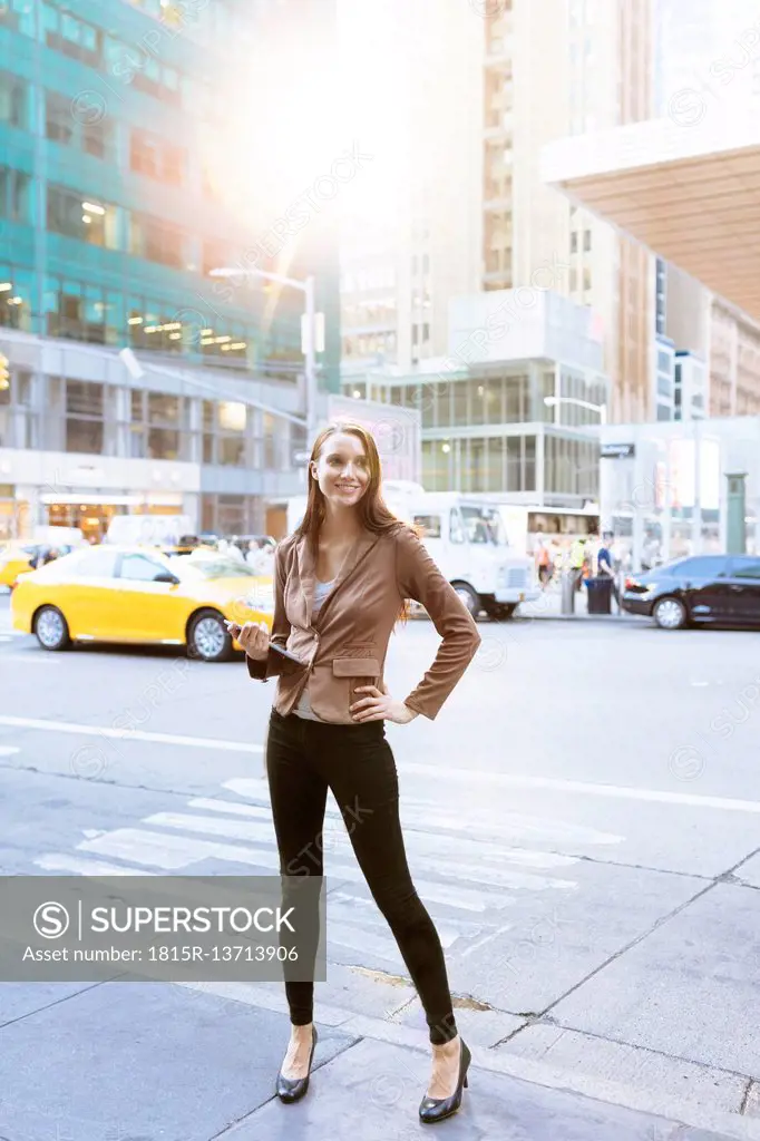 USA, New York, Manhattan, smiling young businesswoman with tablet