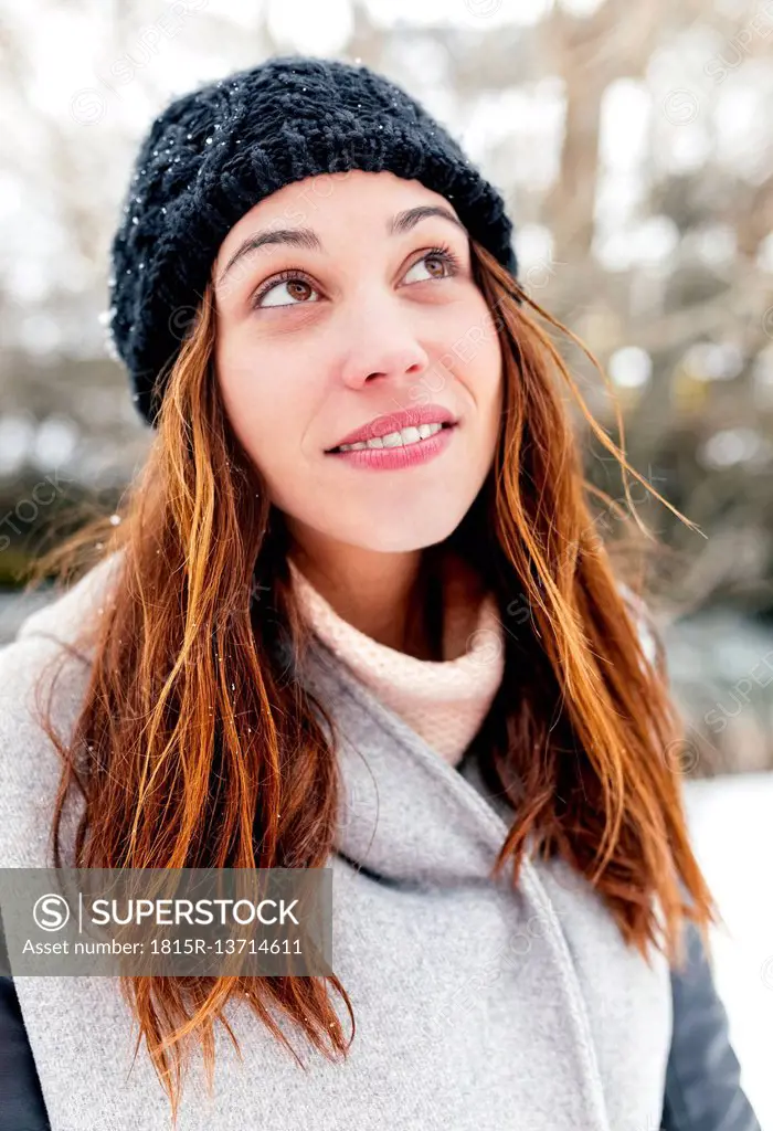 Young woman outdoors in winter looking up