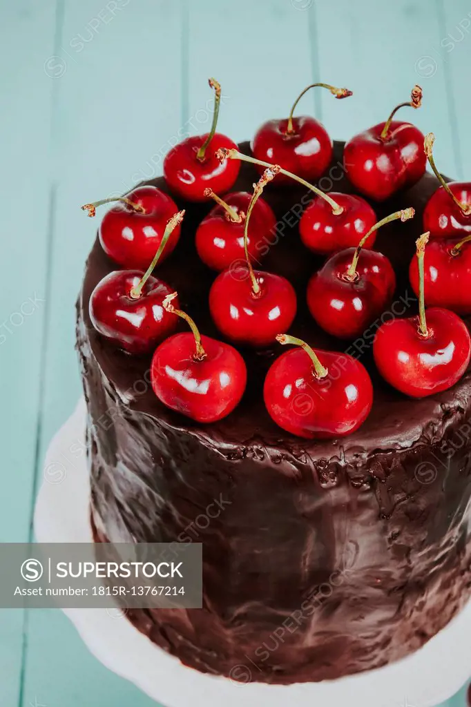 Cherries on cake with chocolate icing