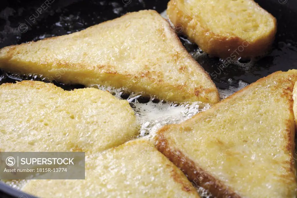 Slices of toast in hot pan, close-up