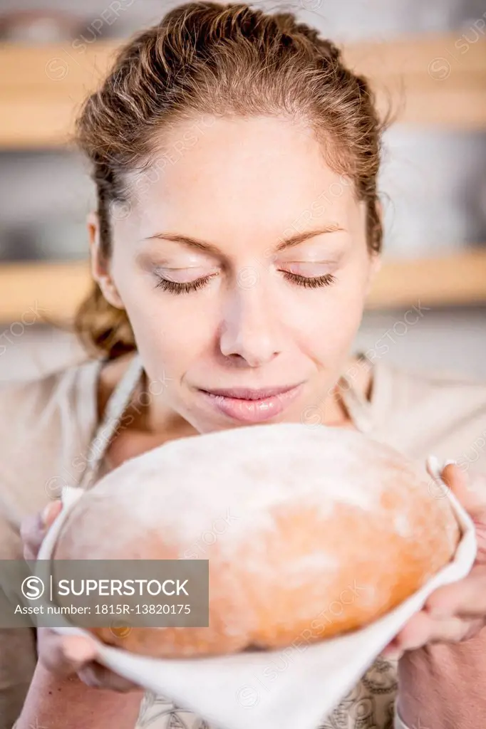 Woman holding loaf of bread