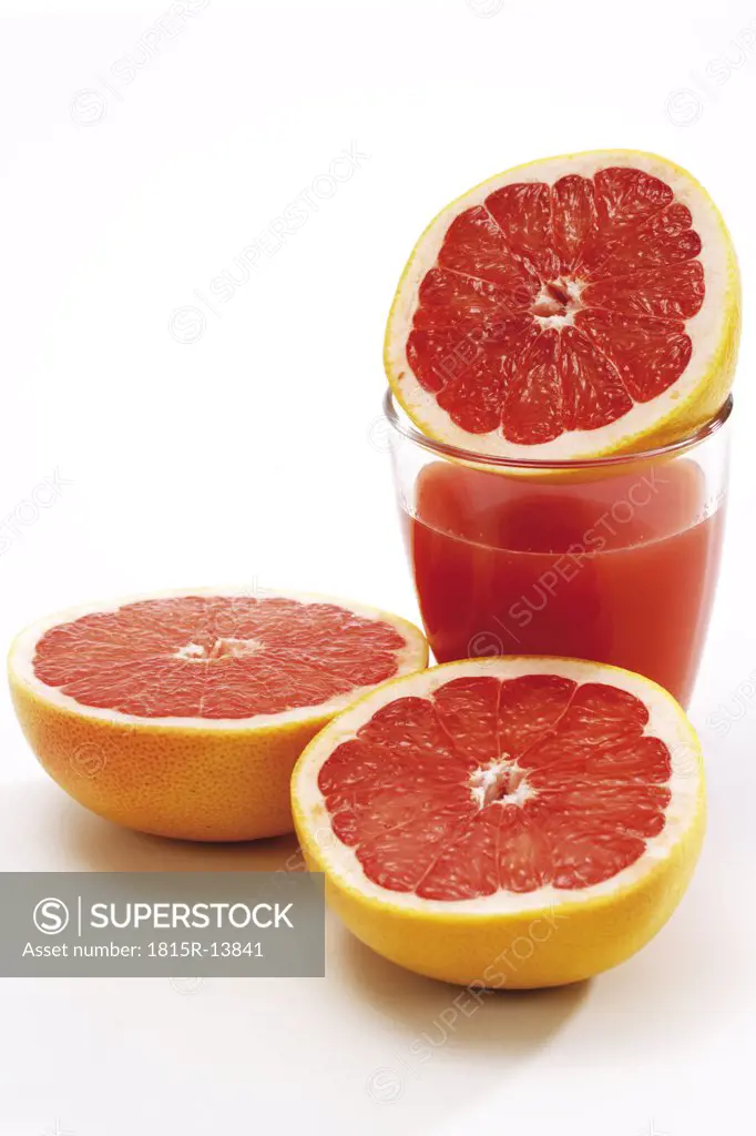 Sliced grapefruits an glass of juice