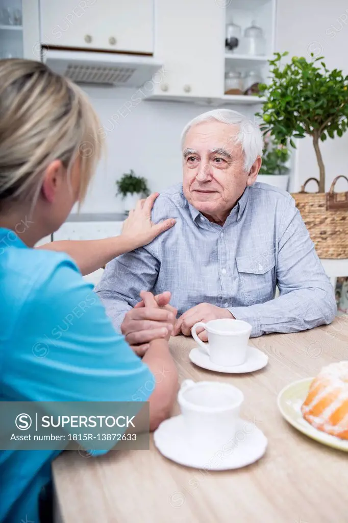 Gereatric nurse listening to elderly patient
