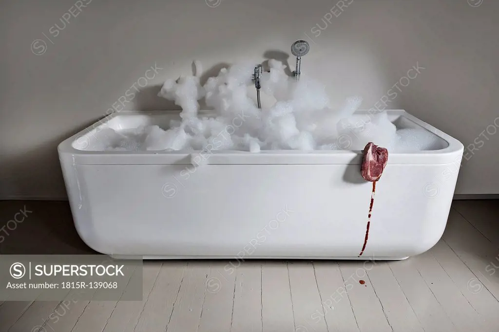 Bathtub with meat in bathroom