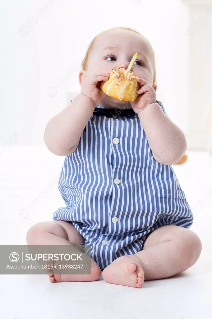 Baby boy eating birthday cake