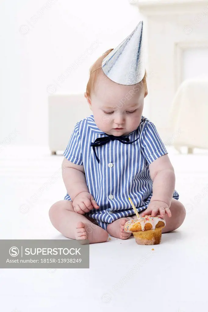 Baby boy testing birthday cake