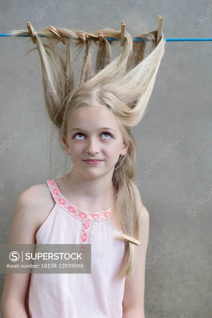 Blond girl's hair drying on clothesline