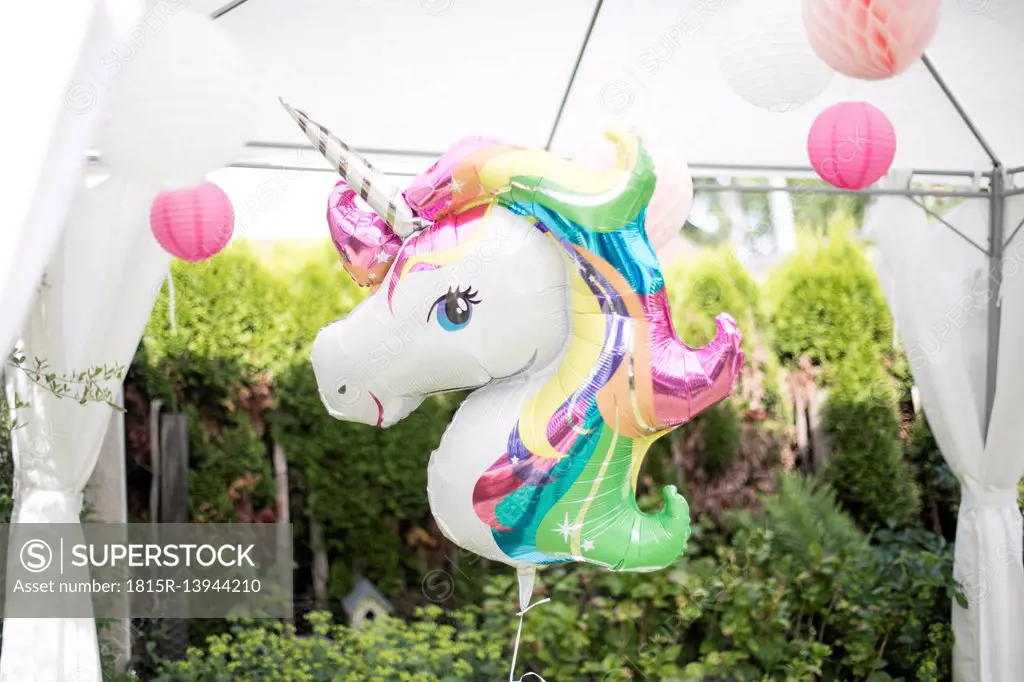 Decoration with unicorn balloon and lampions in a garden