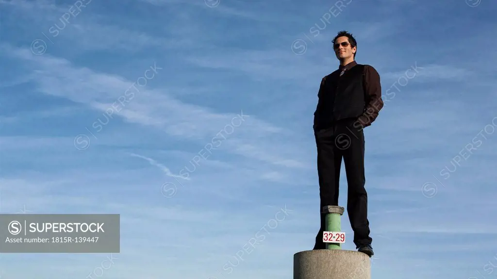 Germany, Munich, Man standing on pole