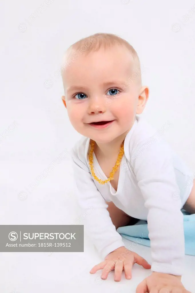 Portrait of baby boy crawling, smiling