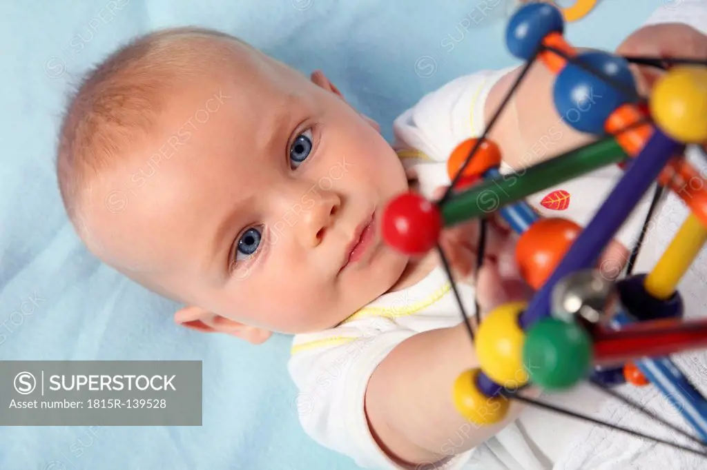 Germany, Bavaria, Baby boy playing with toy