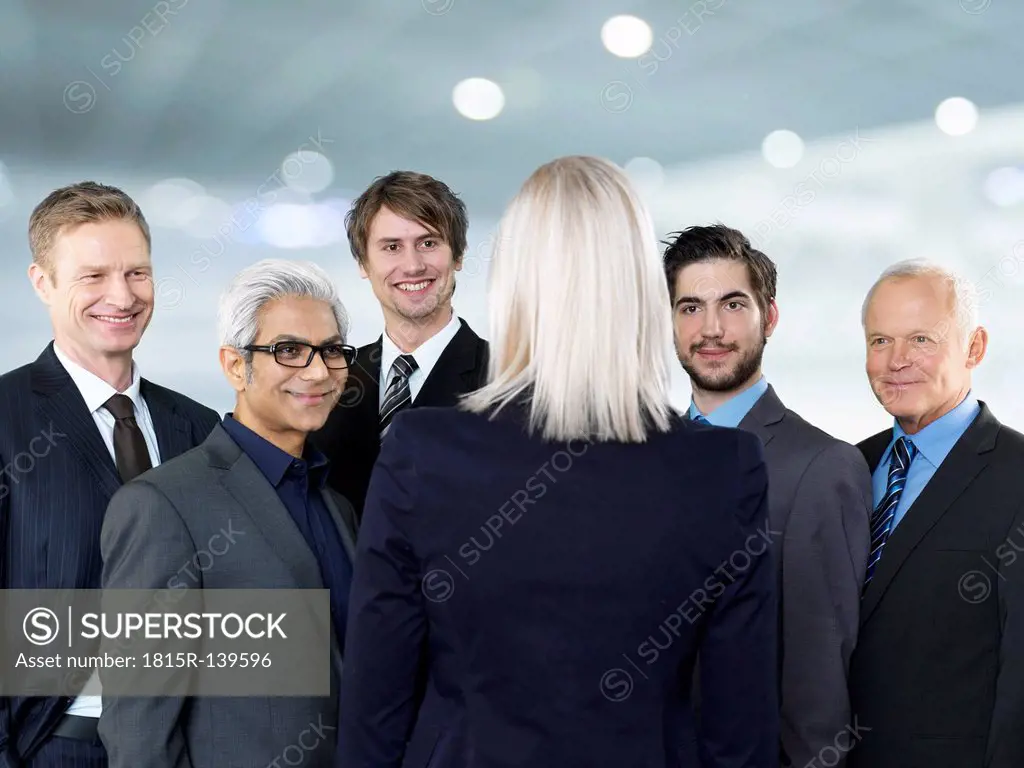 Businessmen and businesswoman talking, smiling