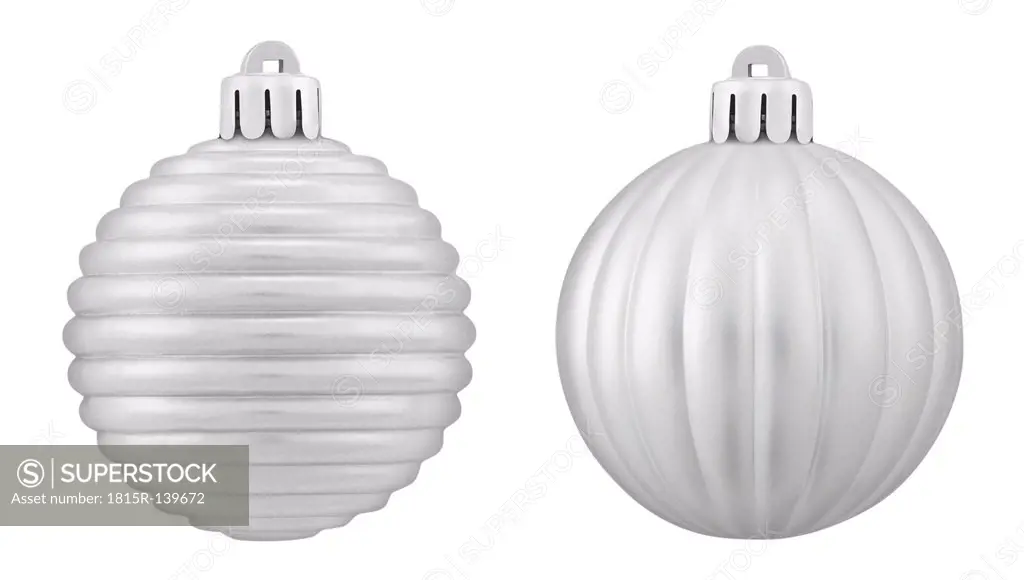 Two silver christmas bauble against white background, close up